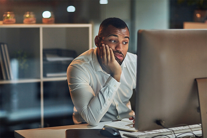 Man Waiting for Computer to Load Screen