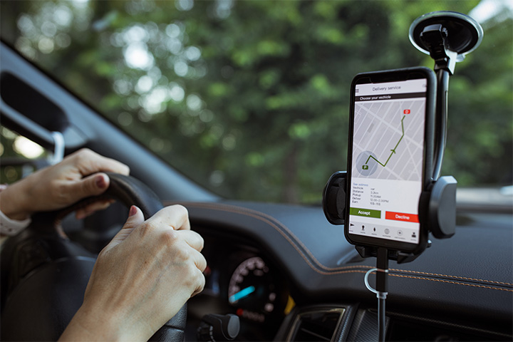 driving-car-and-navigating-gps-on-phone