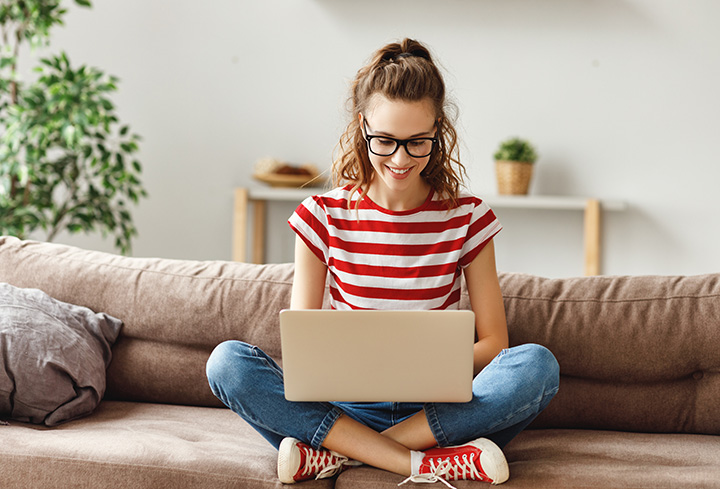 a girl using the internet on her computer