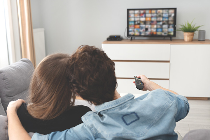 A couple searching for a movie to stream on their tv