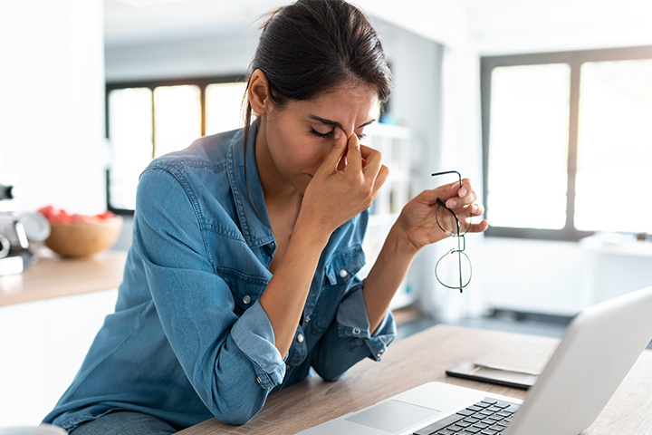 A women frustrated by her slow internet at her computer 