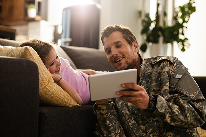 An active service member and daughter using the internet on their tablet
